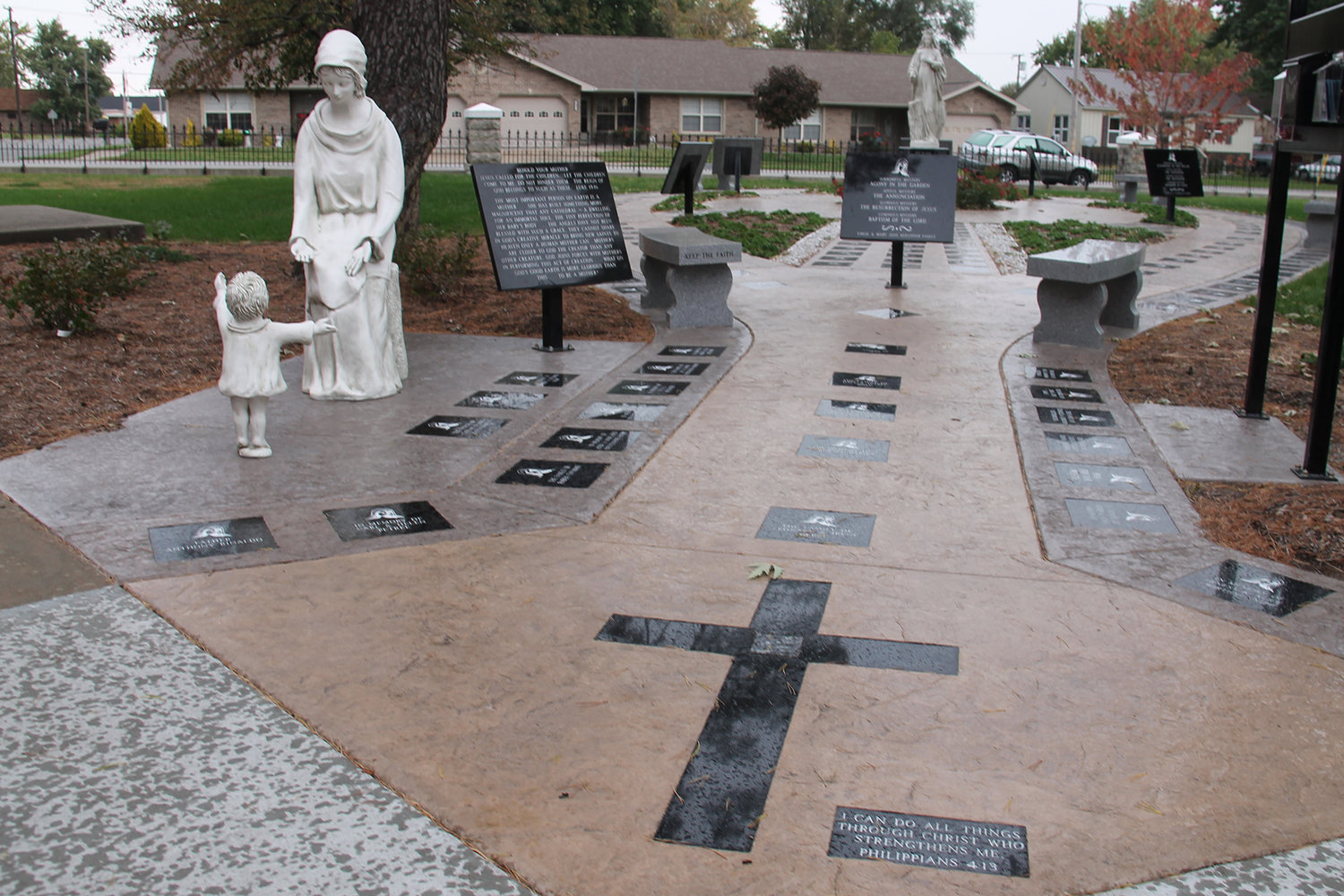 The Rosary Garden outside St. Andrew Church in Tipton includes a paved walkway with embedded stones representing each bead, and information about praying the Rosary.